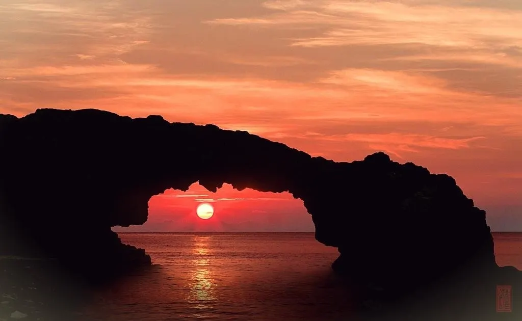 Cổng Tò Vò arch glowing at sunset on Lý Sơn Island